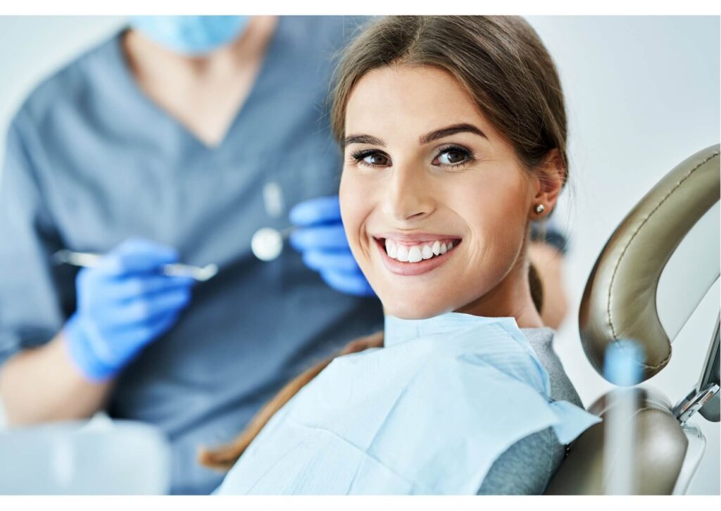 Smiling patient at a cosmetic dentistry appointment discussing bonding vs veneers options with a dentist