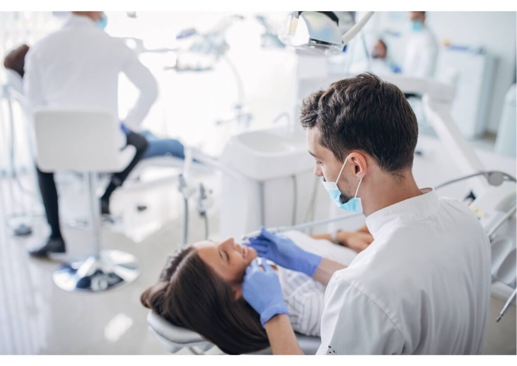 Dentist discussing treatment planning and the cost of dental implants with a patient during a consultation checkup