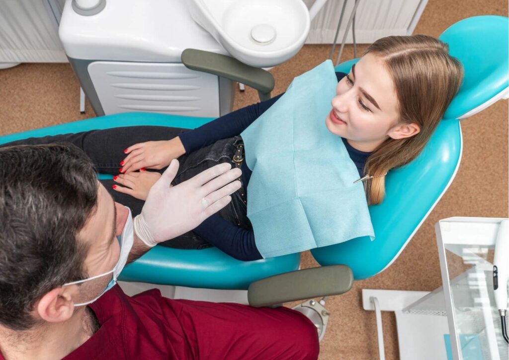 Patient discussing dental implants with a dentist before medical imaging, highlighting considerations for having an MRI with dental implants.