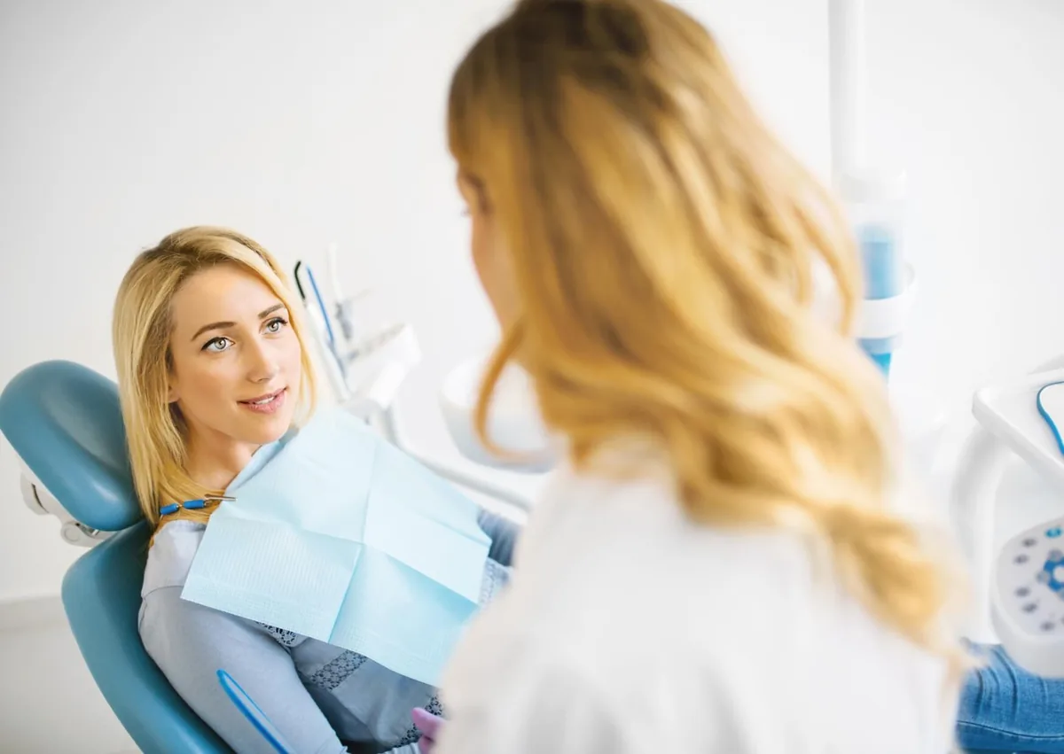 Patient discussing affordable dental implants and treatment options with a dentist during a consultation.