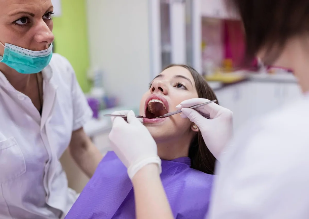 Dentist examining a patient’s teeth for signs of cavities and tooth decay.