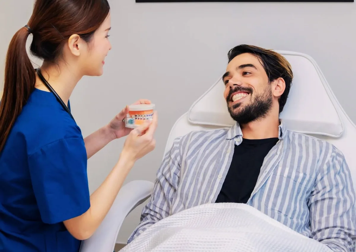Dental professional discussing braces treatment and insurance coverage with a patient.